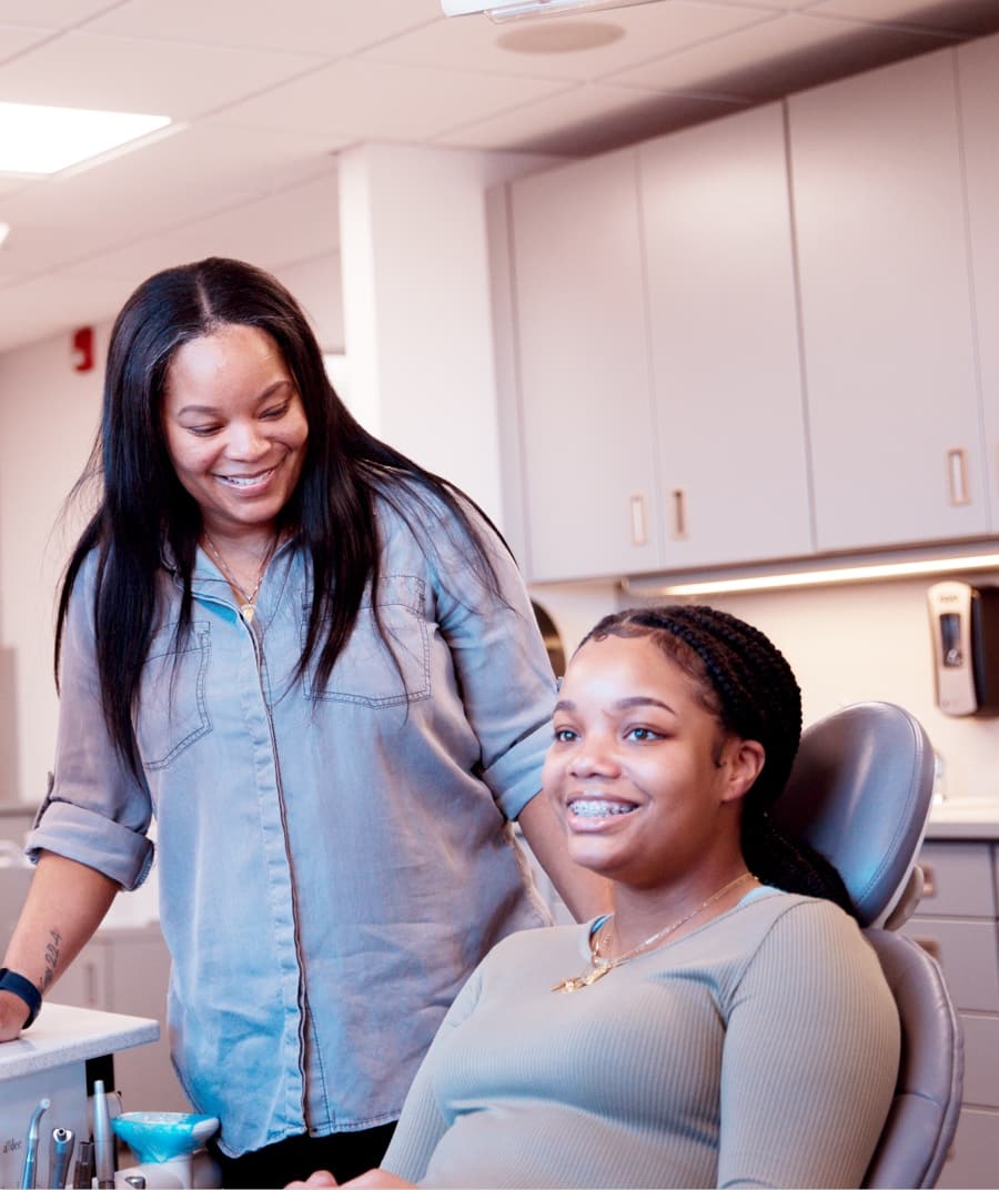 Teen patient and team member smiling during visit