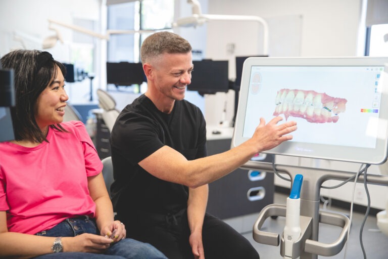 Omaha orthodontist showing a teeth model to a patient during a consultation at Chartrand Orthodontics